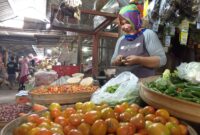 Salah satu pedagang Pasar Basah Trenggalek tengah membersihkan dagangannya (ilustrasi)