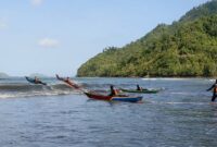 Peserta balap perahu kunting menerjang besarnya ombak Pantai Cengkrong tanda start dimulai