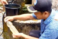 Supriyanto selaku Kepala Dusun Krajan menunjukkan sample air keruh milik warga Desa Prambon.